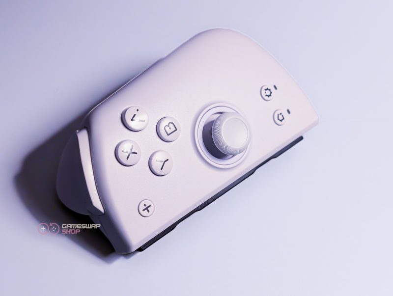 White game controller with buttons and joystick.