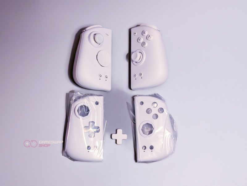 White gaming controllers on light background