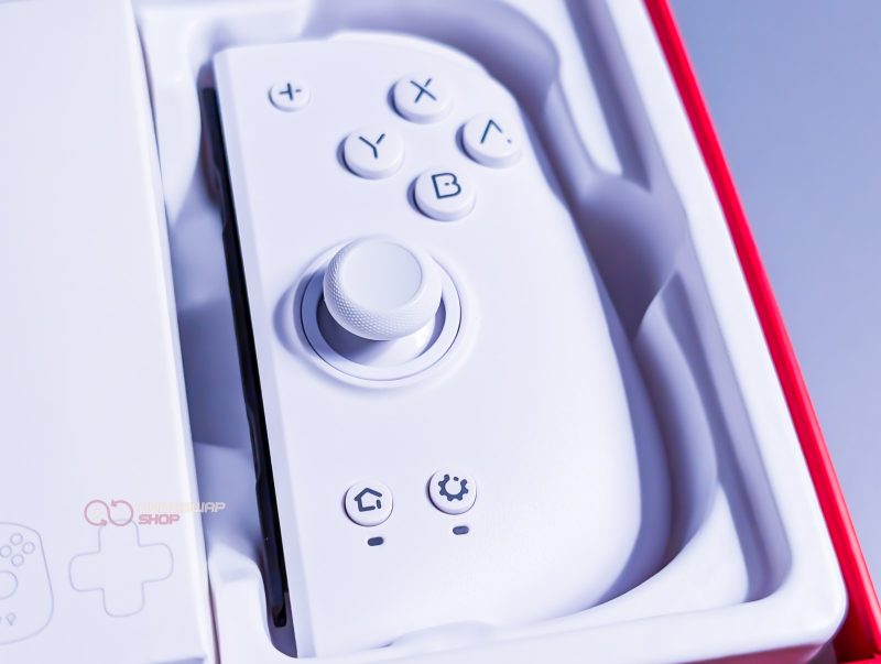 White gaming controller in packaging box.