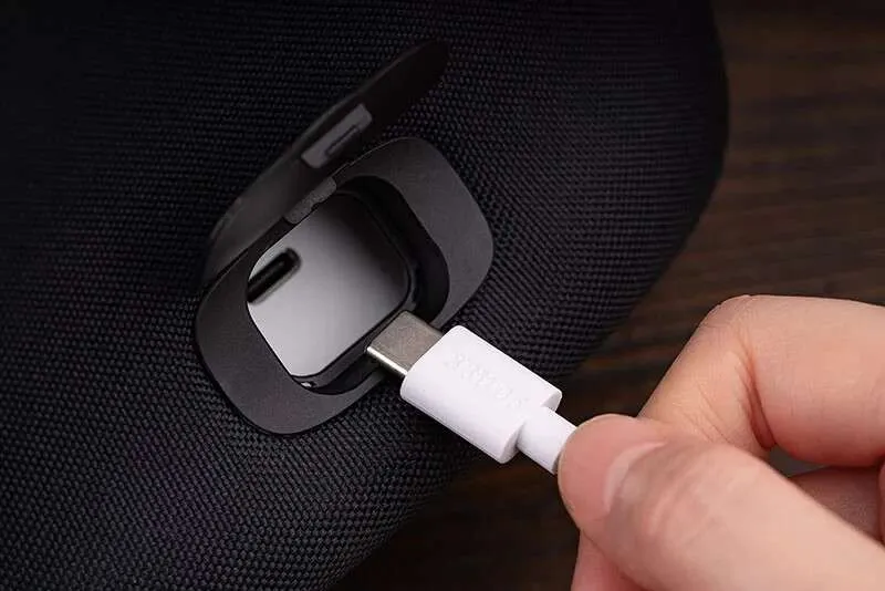 Inserting USB-C cable into device port.