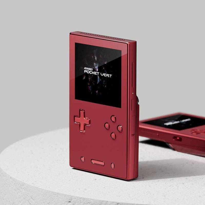 Red handheld gaming console on white surface.